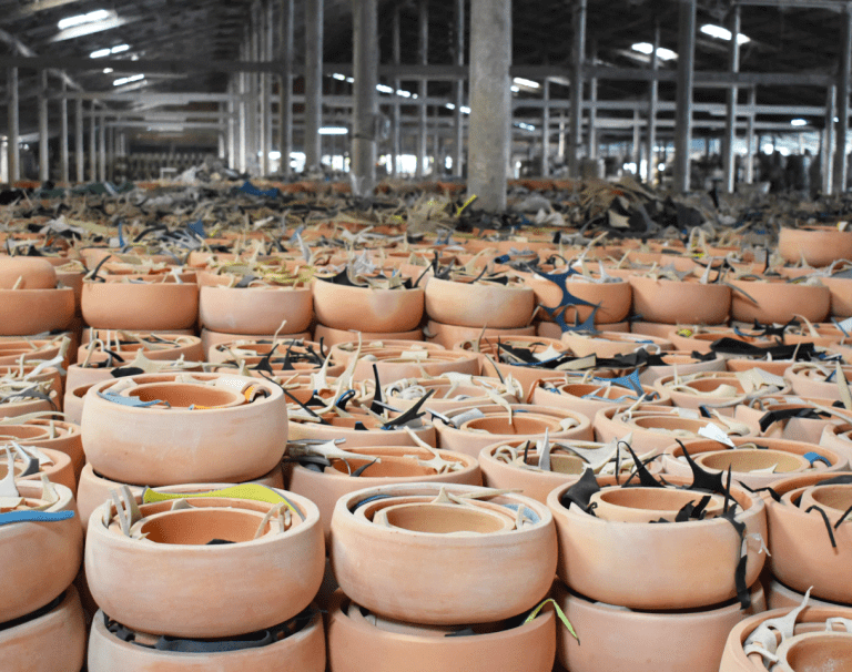 Rows of terracotta pots stacked in the warehouse